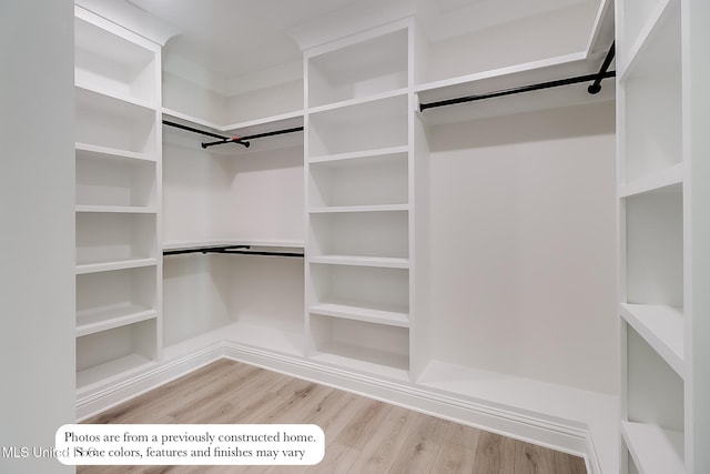 spacious closet featuring wood finished floors