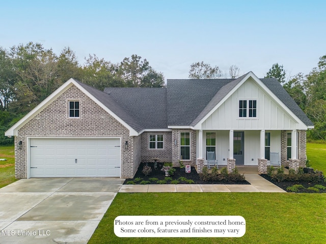 view of front facade featuring an attached garage, brick siding, board and batten siding, a porch, and driveway