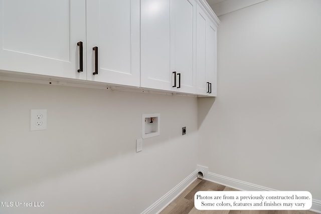 laundry area featuring cabinet space, washer hookup, baseboards, wood finished floors, and hookup for an electric dryer