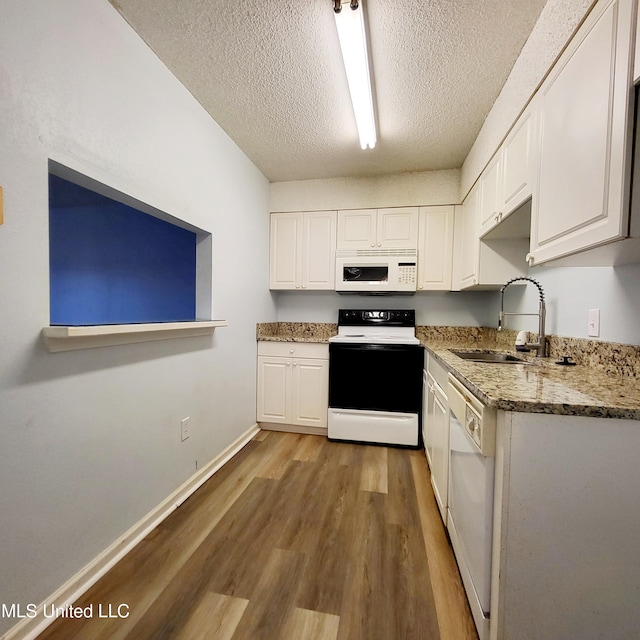 kitchen featuring white cabinets, a textured ceiling, white appliances, and hardwood / wood-style flooring