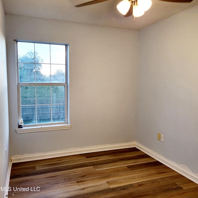 unfurnished room featuring hardwood / wood-style flooring, ceiling fan, and a wealth of natural light