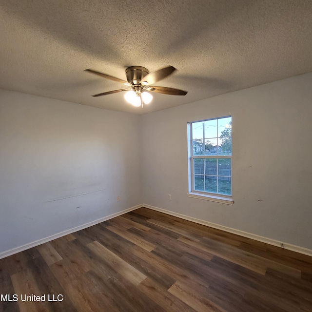 spare room with ceiling fan, dark hardwood / wood-style flooring, and a textured ceiling