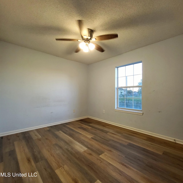 empty room with a textured ceiling, ceiling fan, and dark wood-type flooring