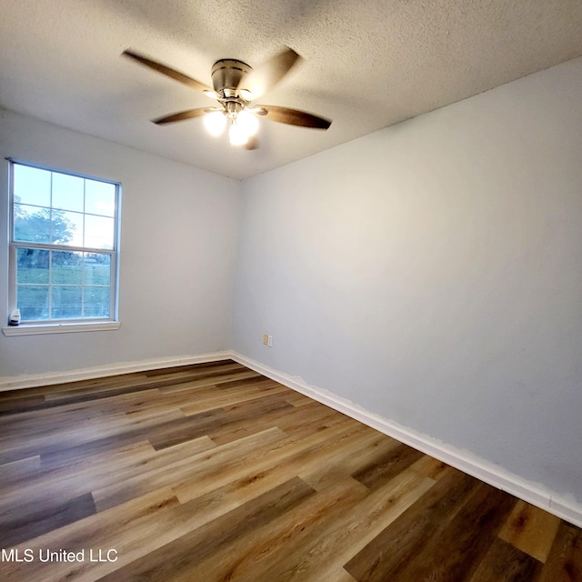 spare room featuring wood-type flooring, a textured ceiling, and ceiling fan