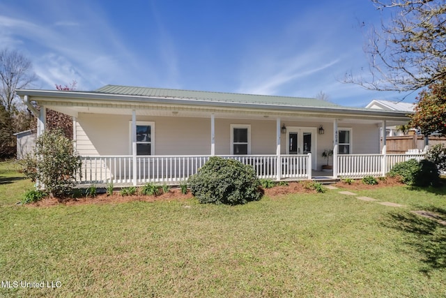 view of front of property featuring metal roof, french doors, a porch, and a front lawn