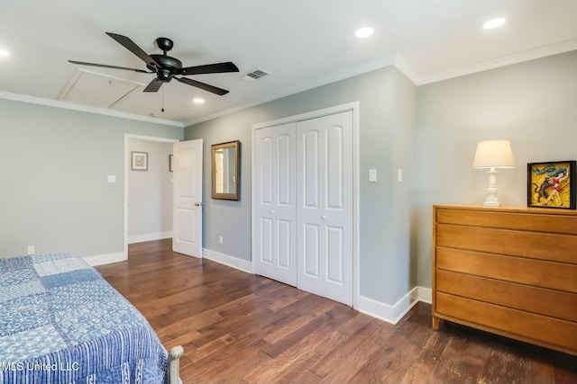 bedroom featuring attic access, visible vents, baseboards, and wood finished floors