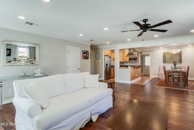 living room featuring crown molding, recessed lighting, dark wood-type flooring, ceiling fan, and baseboards