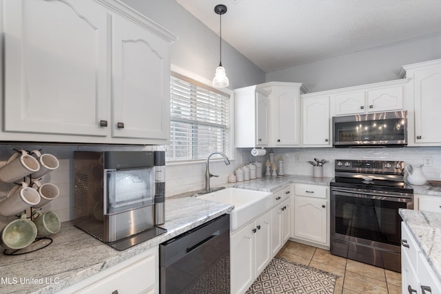 kitchen featuring pendant lighting, sink, stainless steel appliances, and white cabinets