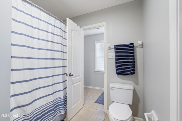 bathroom featuring tile patterned flooring, toilet, and a shower with shower curtain