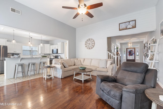 living room with light hardwood / wood-style flooring and ceiling fan