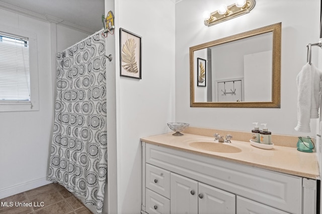 bathroom with tile patterned floors, vanity, and crown molding