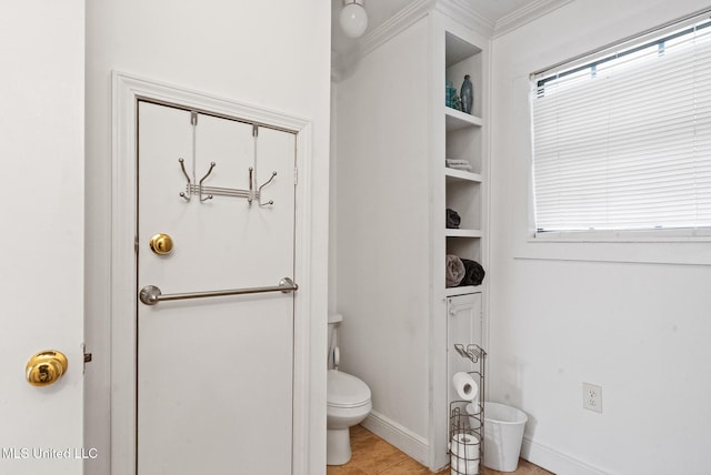 bathroom with baseboards and toilet