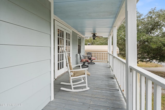 wooden deck with ceiling fan and a porch