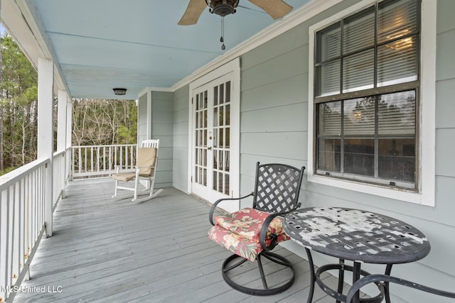 wooden deck with ceiling fan, french doors, and a porch