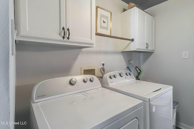 washroom with cabinet space and washer and clothes dryer