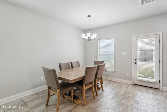 dining area with a chandelier and a healthy amount of sunlight