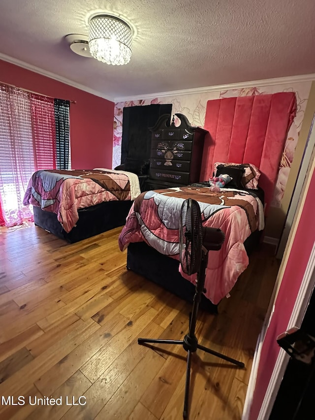 1052 Briarfield Rd, Jackson, MS 39211 - bedroom with hardwood / wood-style flooring, a textured ceiling, crown molding, and a chandelier