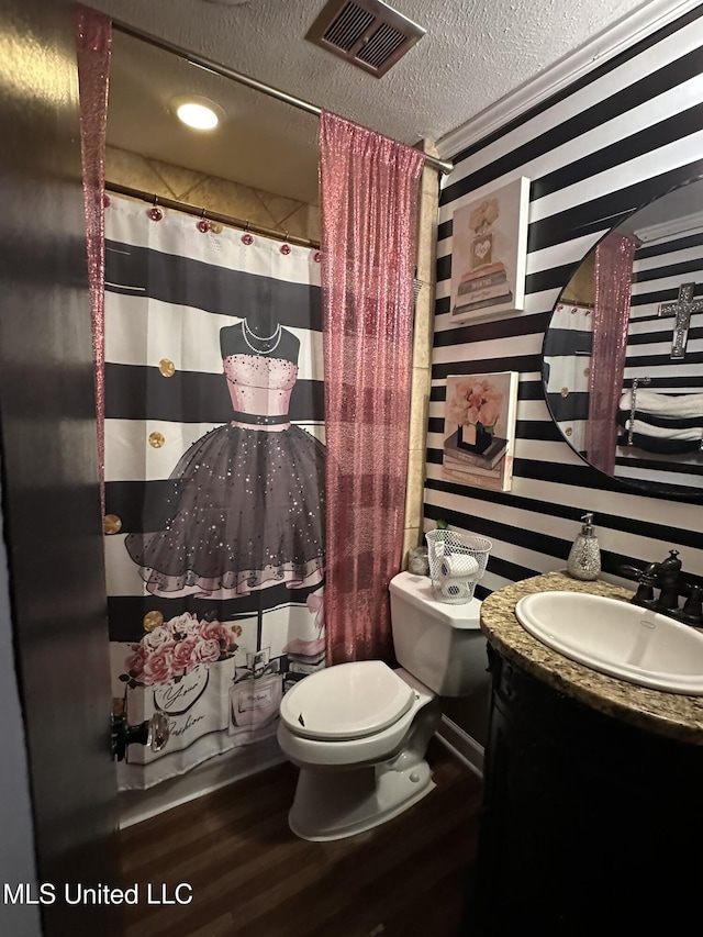 1052 Briarfield Rd, Jackson, MS 39211 - bathroom featuring wood finished floors, toilet, a textured ceiling, vanity, and curtained shower