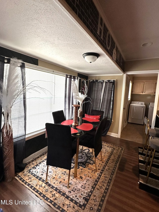 1052 Briarfield Rd, Jackson, MS 39211 - dining area with wood finished floors, washing machine and dryer, baseboards, and a textured ceiling