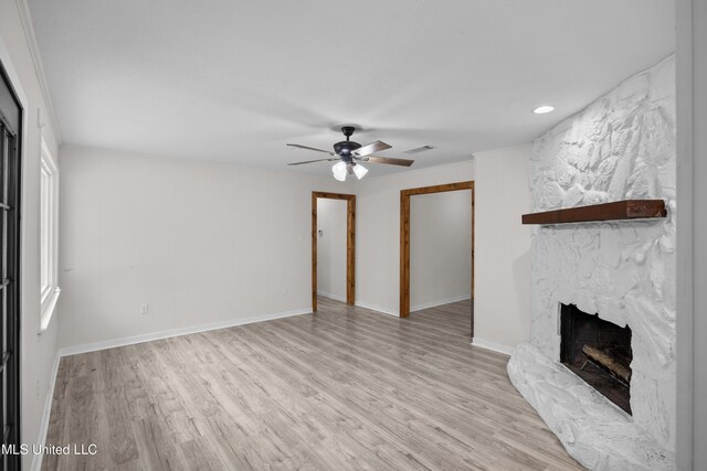 2389 Napoleon Ave, Pearl, MS 39208 - unfurnished living room with ceiling fan, a stone fireplace, wood finished floors, and visible vents
