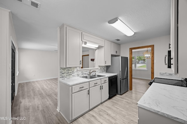2389 Napoleon Ave, Pearl, MS 39208 - kitchen with light countertops, visible vents, black appliances, and a sink