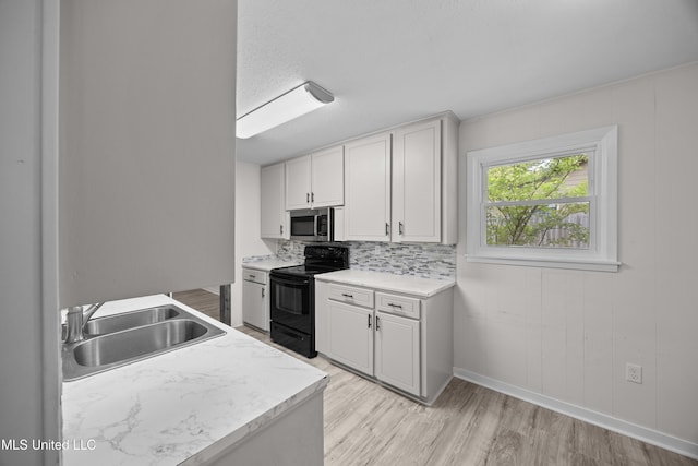 2389 Napoleon Ave, Pearl, MS 39208 - kitchen featuring electric range, stainless steel microwave, a sink, and light countertops