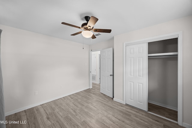 2389 Napoleon Ave, Pearl, MS 39208 - unfurnished bedroom with wood finished floors, visible vents, a ceiling fan, a closet, and baseboards