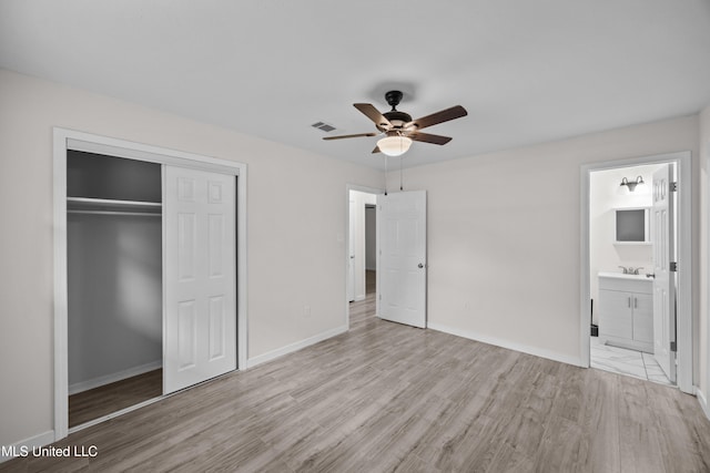 2389 Napoleon Ave, Pearl, MS 39208 - unfurnished bedroom with a sink, visible vents, baseboards, wood finished floors, and a closet