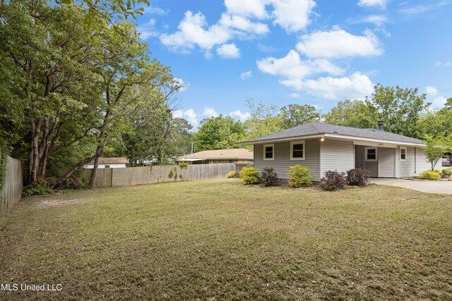 2389 Napoleon Ave, Pearl, MS 39208 - view of yard with fence, an attached carport, and concrete driveway