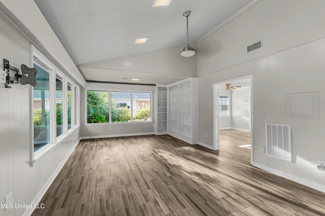 interior space with vaulted ceiling, ceiling fan, a textured ceiling, and dark hardwood / wood-style flooring