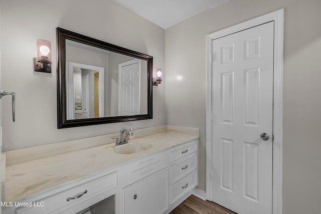 bathroom featuring vanity, a textured ceiling, and wood-type flooring