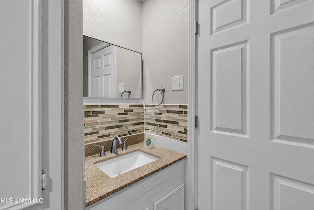 bathroom with vanity and decorative backsplash