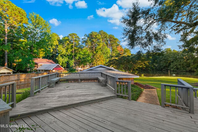 wooden deck featuring a lawn