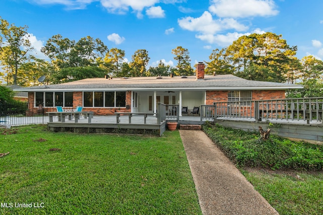 ranch-style home featuring a front yard and a deck