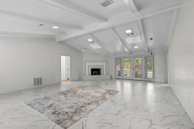 living room featuring french doors, a textured ceiling, vaulted ceiling with beams, and a high end fireplace