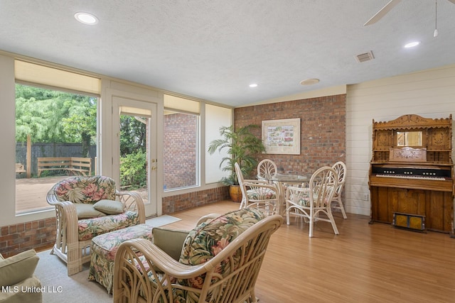 20 Peachtree Ln, Madison, MS 39110 - living room featuring wood finished floors, a textured ceiling, brick wall, a ceiling fan, and recessed lighting