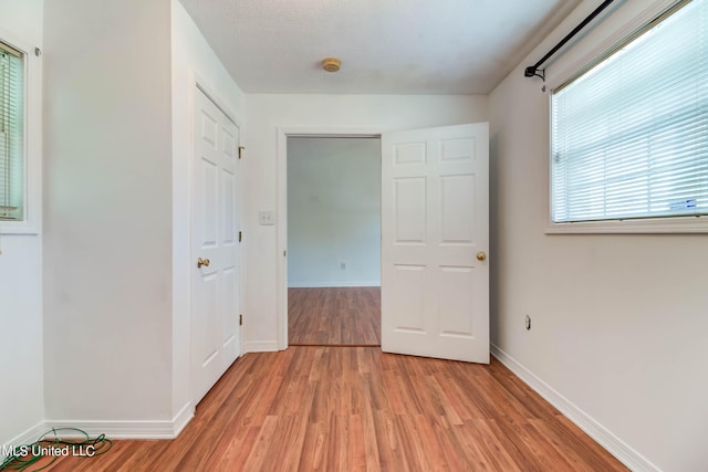 interior space featuring multiple windows and light wood-type flooring