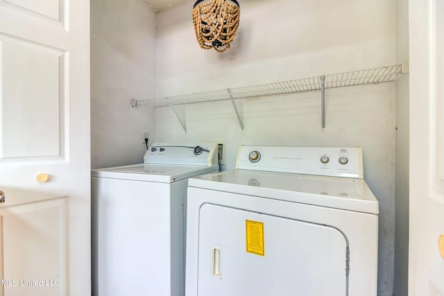 clothes washing area featuring separate washer and dryer