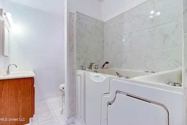 bathroom featuring vanity, toilet, and a tub