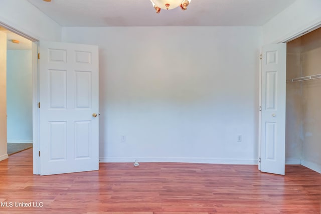 unfurnished bedroom featuring light wood-type flooring and a closet