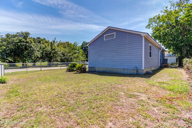 view of side of home with a yard