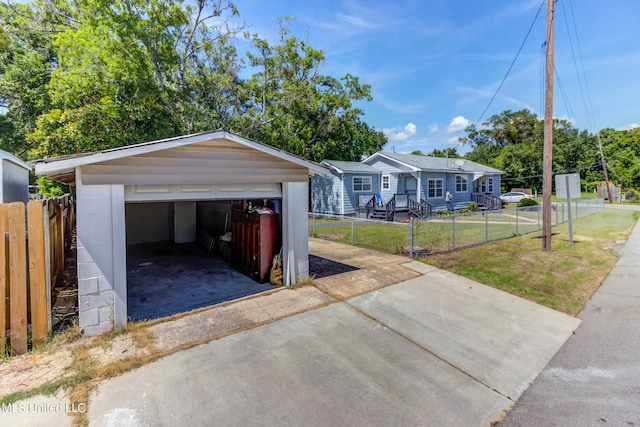 view of front of house with a garage, a front lawn, and an outdoor structure