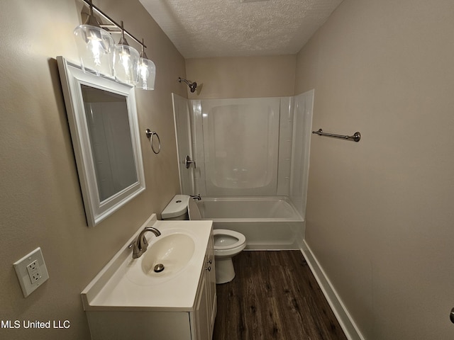 bathroom featuring toilet, vanity, shower / bathtub combination, wood finished floors, and a textured ceiling