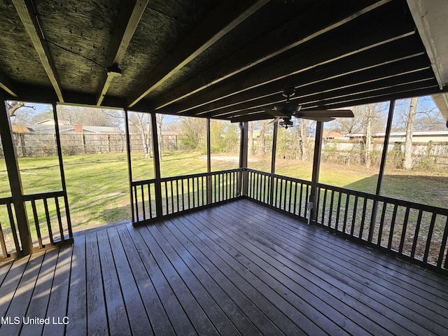 wooden deck featuring a ceiling fan, a yard, and fence