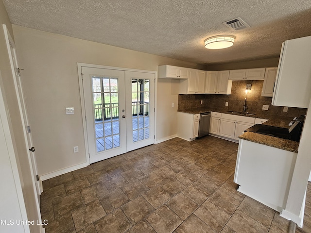 kitchen with a sink, decorative backsplash, french doors, stainless steel dishwasher, and dark countertops