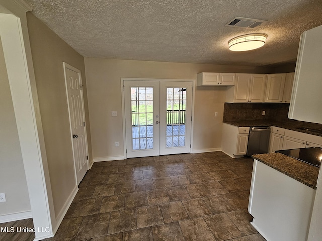 kitchen with visible vents, french doors, stainless steel dishwasher, dark countertops, and backsplash