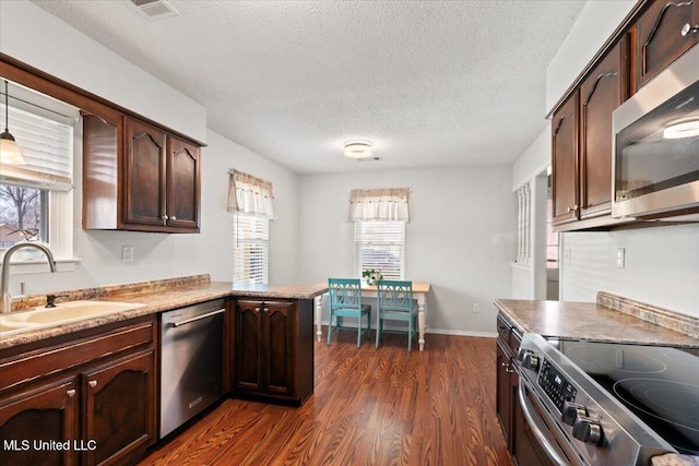 kitchen featuring a sink, stainless steel appliances, plenty of natural light, and dark wood-style flooring