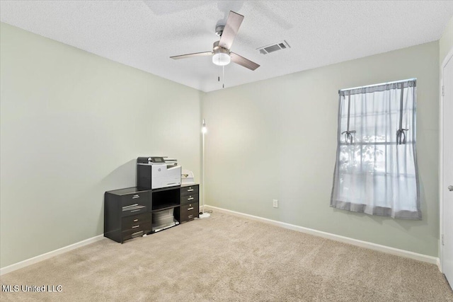 office area featuring baseboards, light carpet, and a ceiling fan