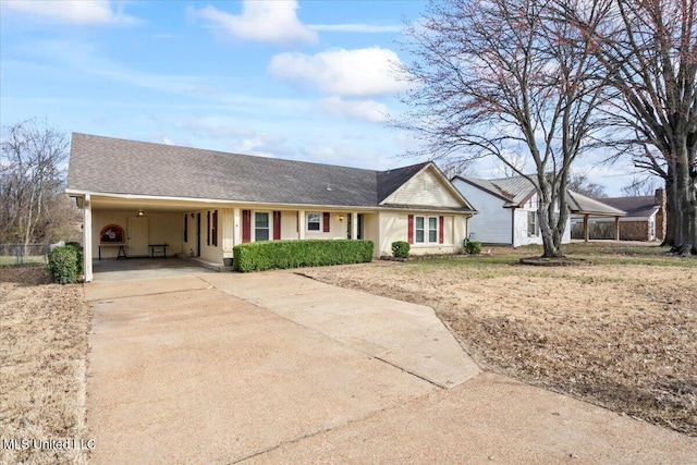 single story home with an attached carport, concrete driveway, and roof with shingles