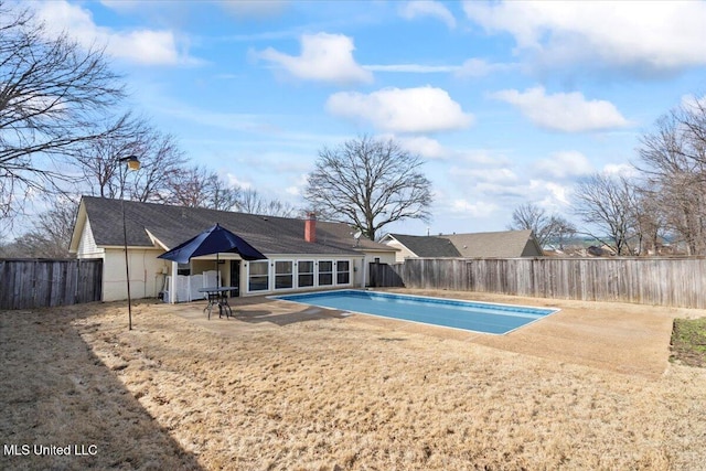 view of swimming pool featuring a fenced in pool, a fenced backyard, and a patio area